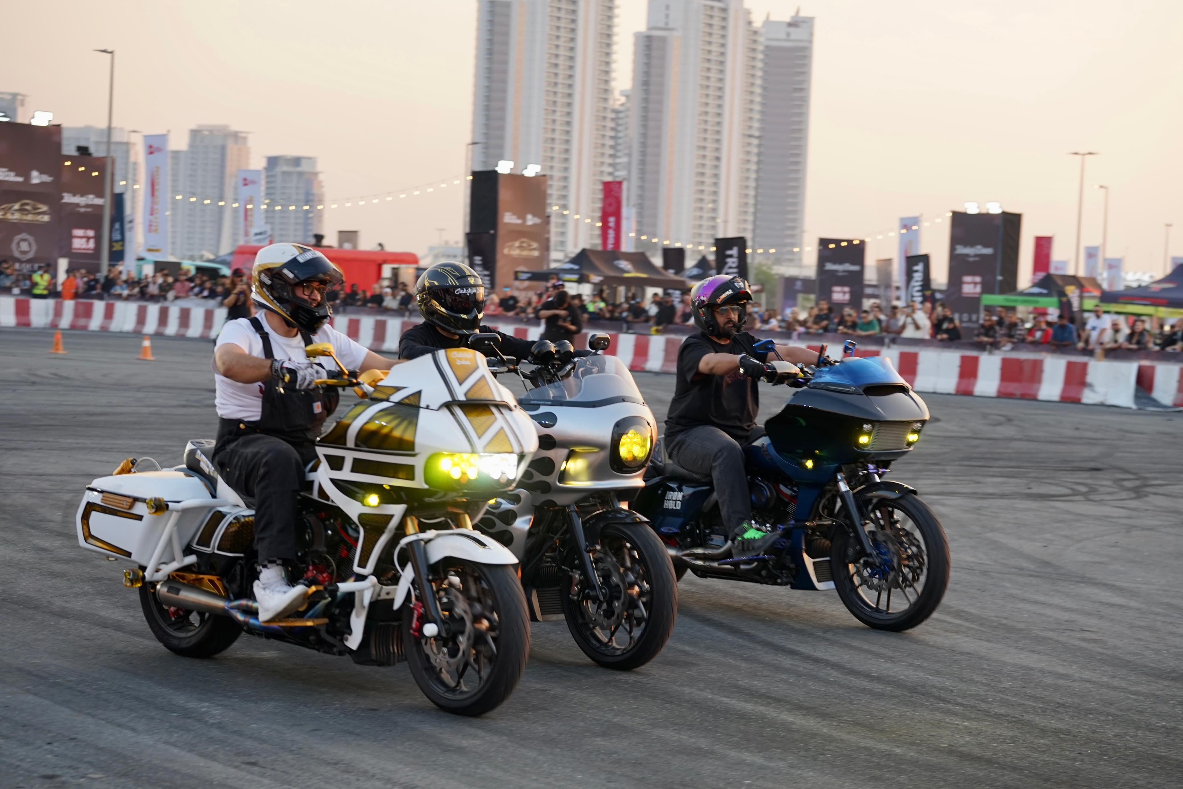 Custom Harley-Davidson baggers riding at a Dubai event